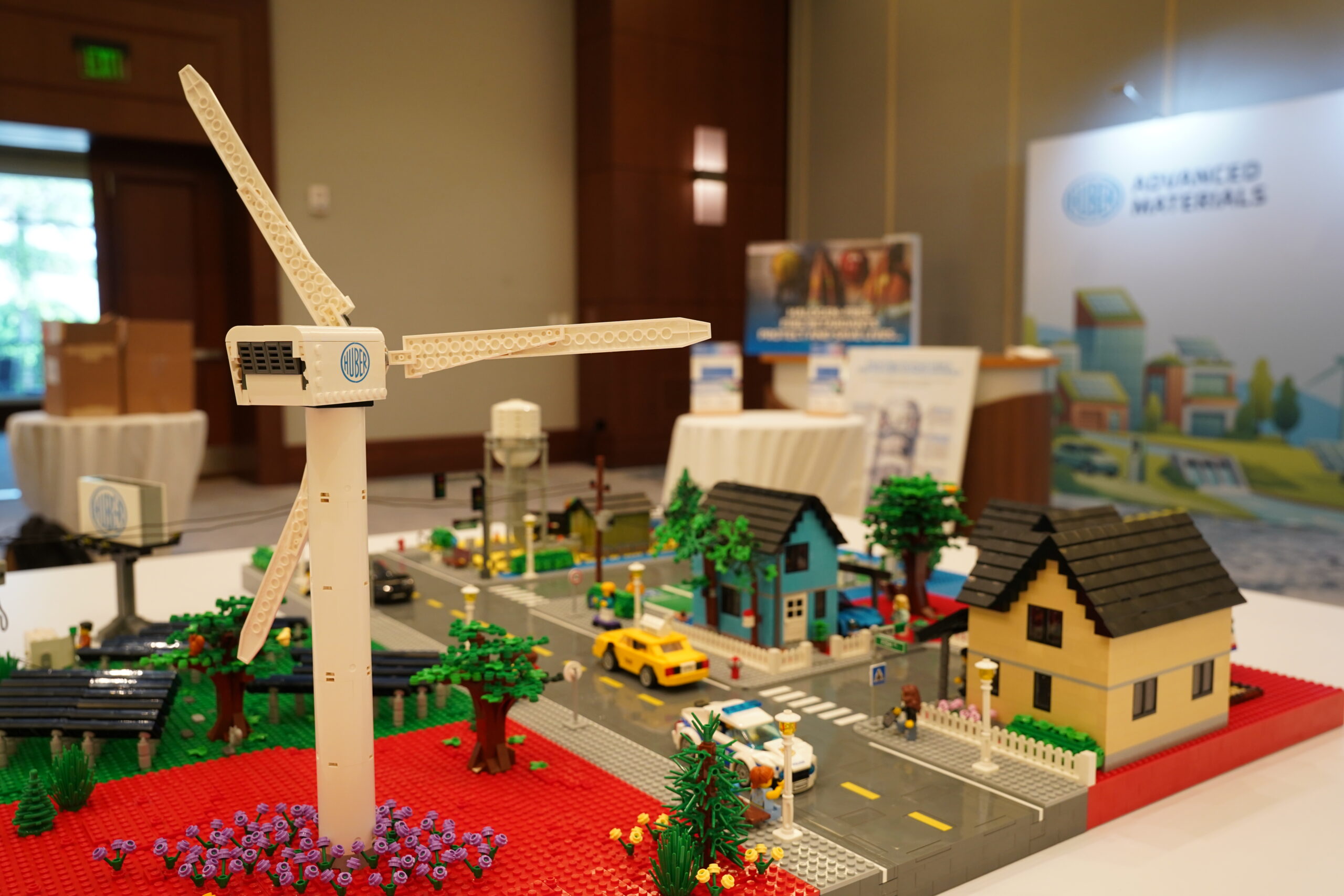 LEGO wind turbine and Huber city model in front of the Huber Advanced Materials booth