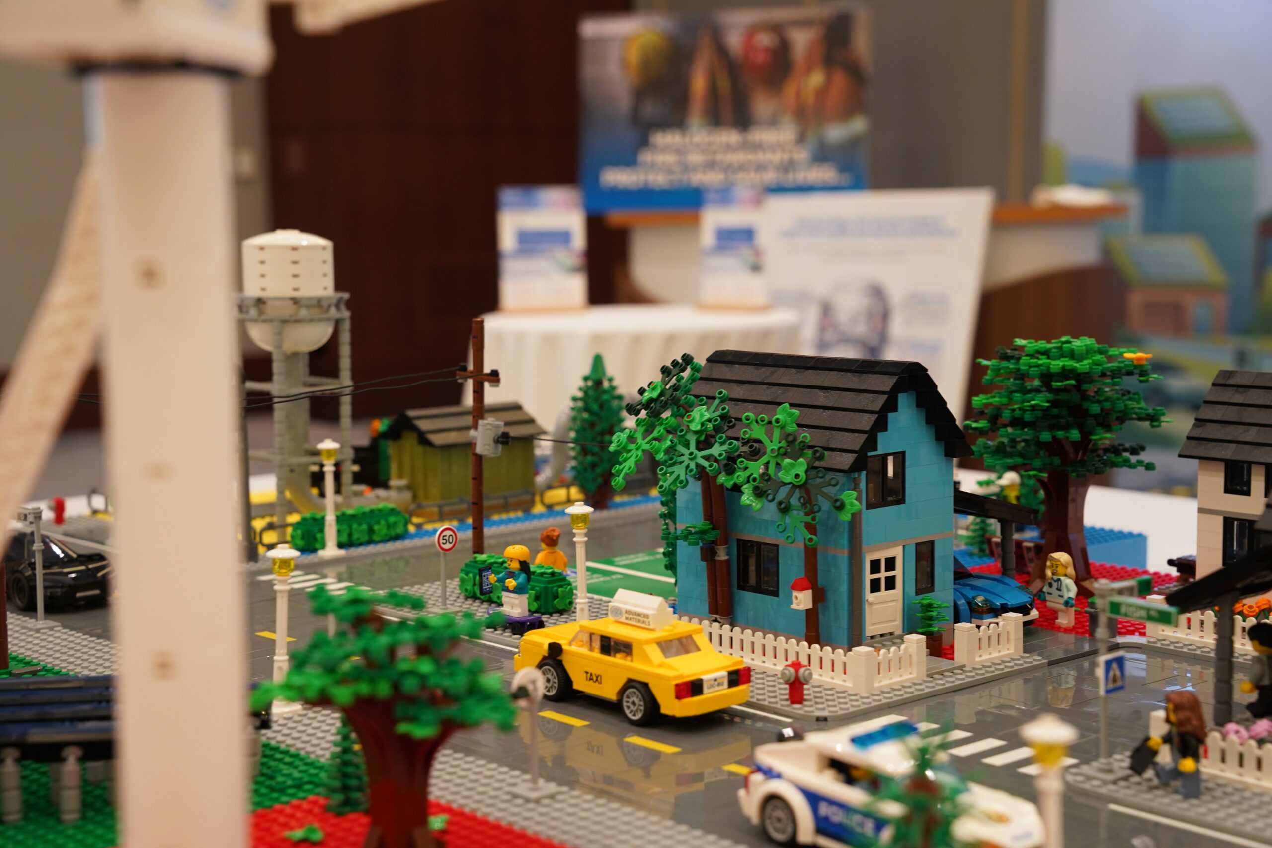 Huber LEGO city neighborhood with branded materials booth details in the background